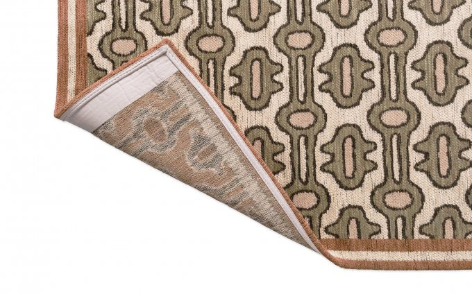 Sanderson Matmi Avocado 148107 rug corner turned to show the backing