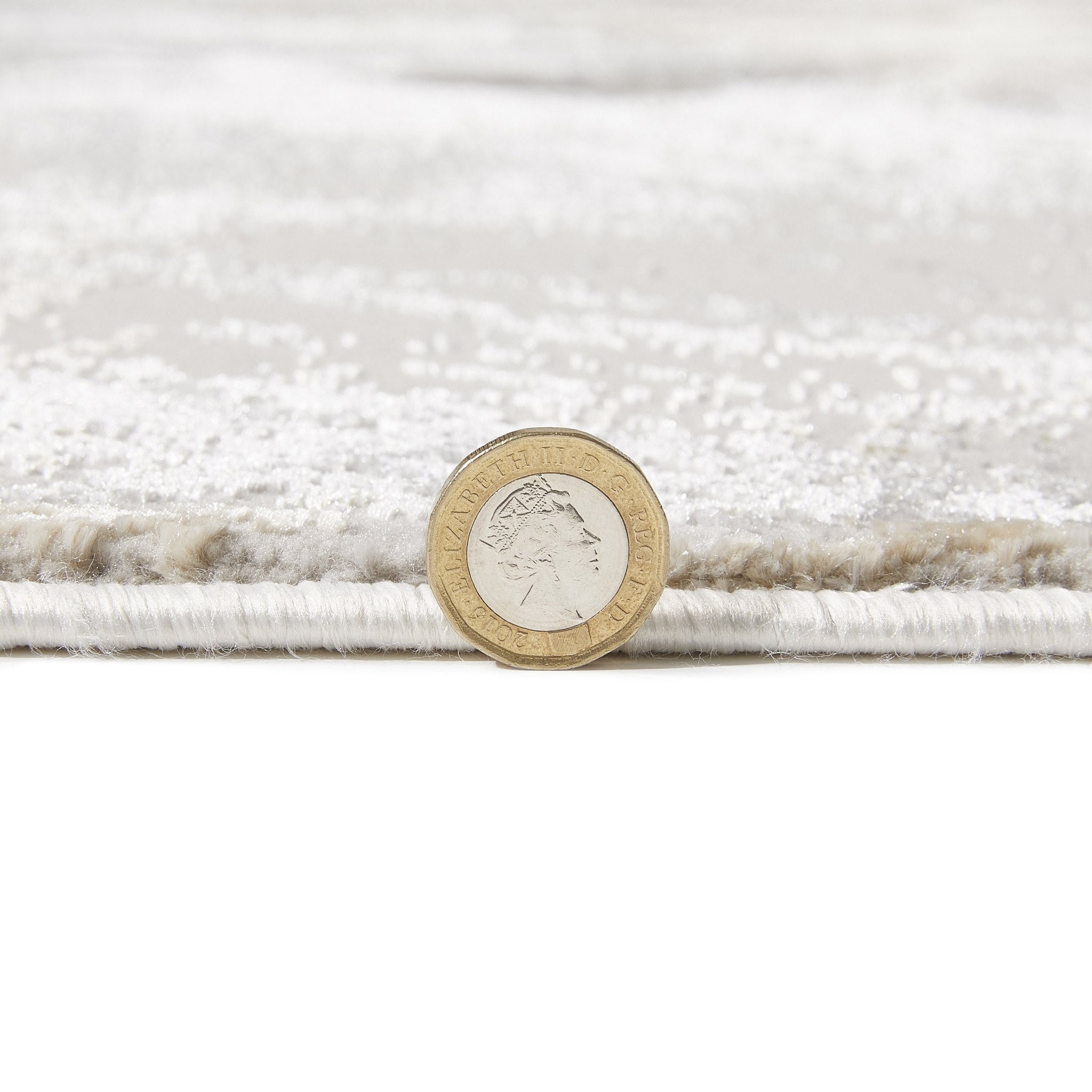 Santa Monica Grey Beige rug pile height shown against a coin for scale